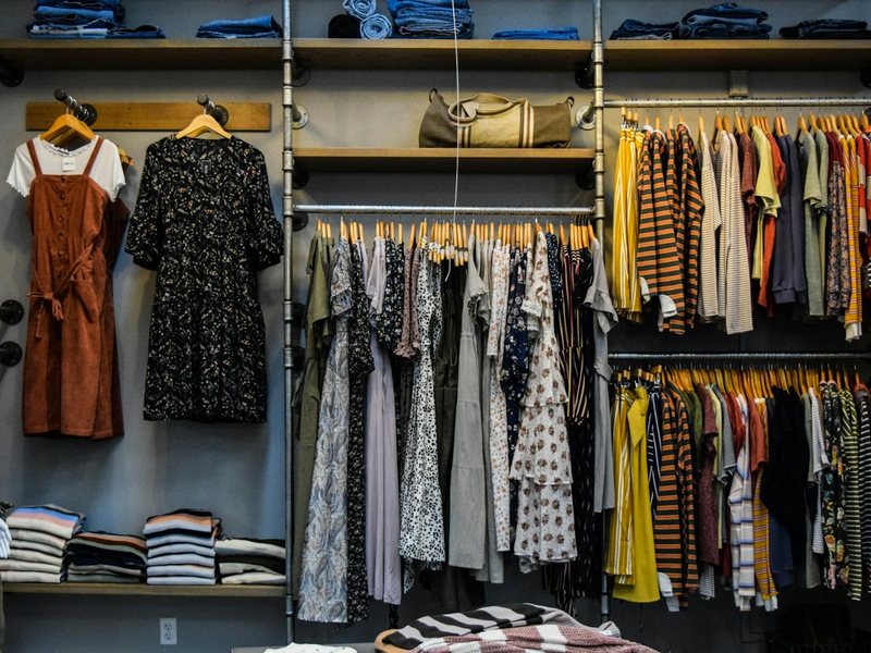 Garments sorted by type on retail rails, standing in for category selection