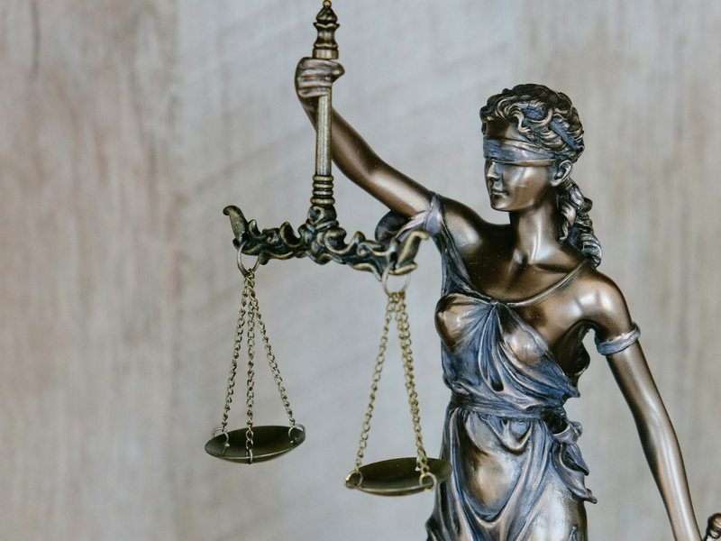 A statue of Justice holding balanced scales